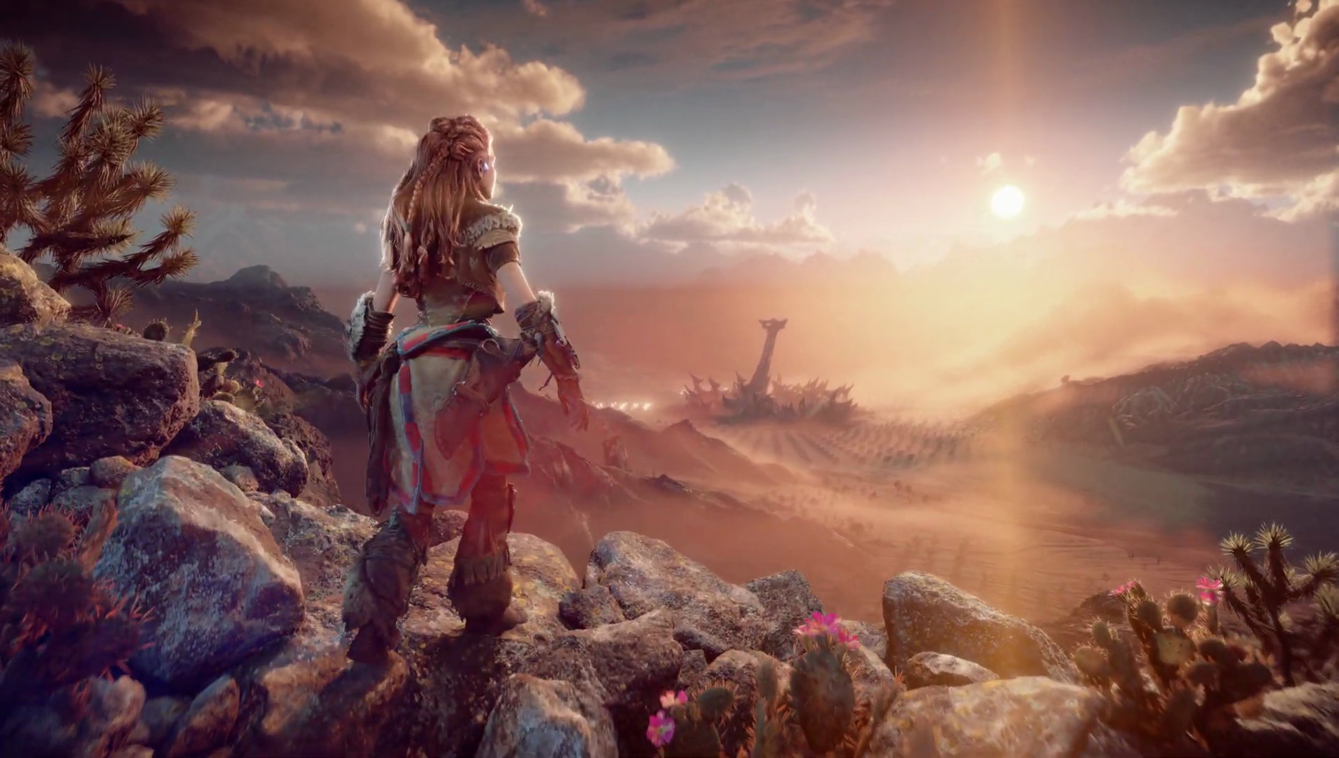 Aloy stares into the distance over the hills at sunset in Horizon Forbidden West.