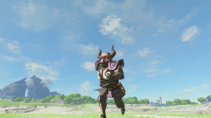 The Legend of Zelda Breath of the Wild Screenshot of Link running through a field wearing gray armor inspired by Spirit Tracks.