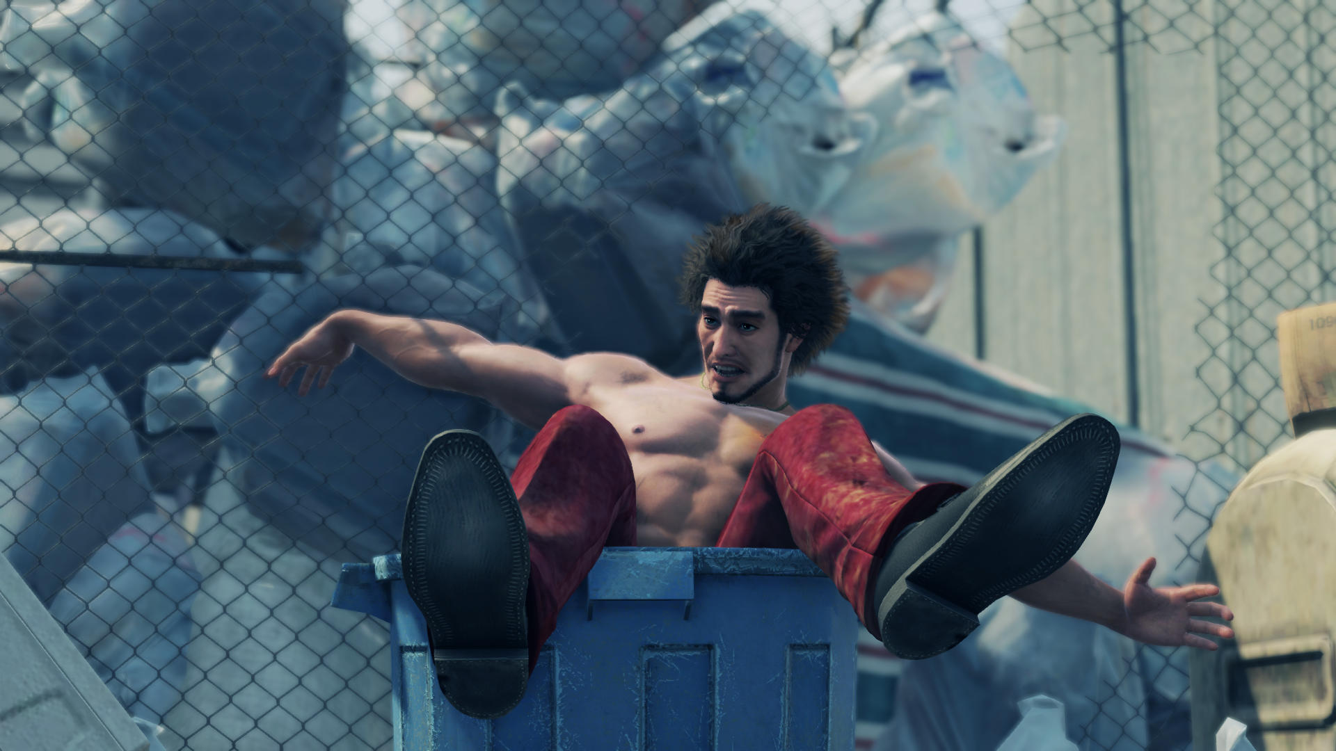 Ichiban Kasuga wearing only pants and shoes, seemingly tossed into a trash can as he flails his arms.