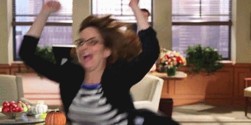 Woman running out of an office excitedly cheering