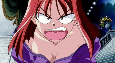Close-up image of red-haired woman in a low-cut purple dress angrily shouting at the viewer.