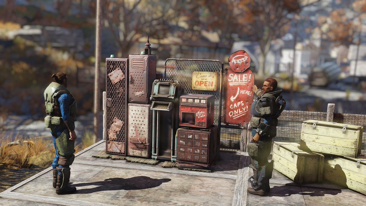 One character on the right gestures toward a beaten up vending machine with a sign that reads "Sale! Here! Caps only!" while another player character looks on.