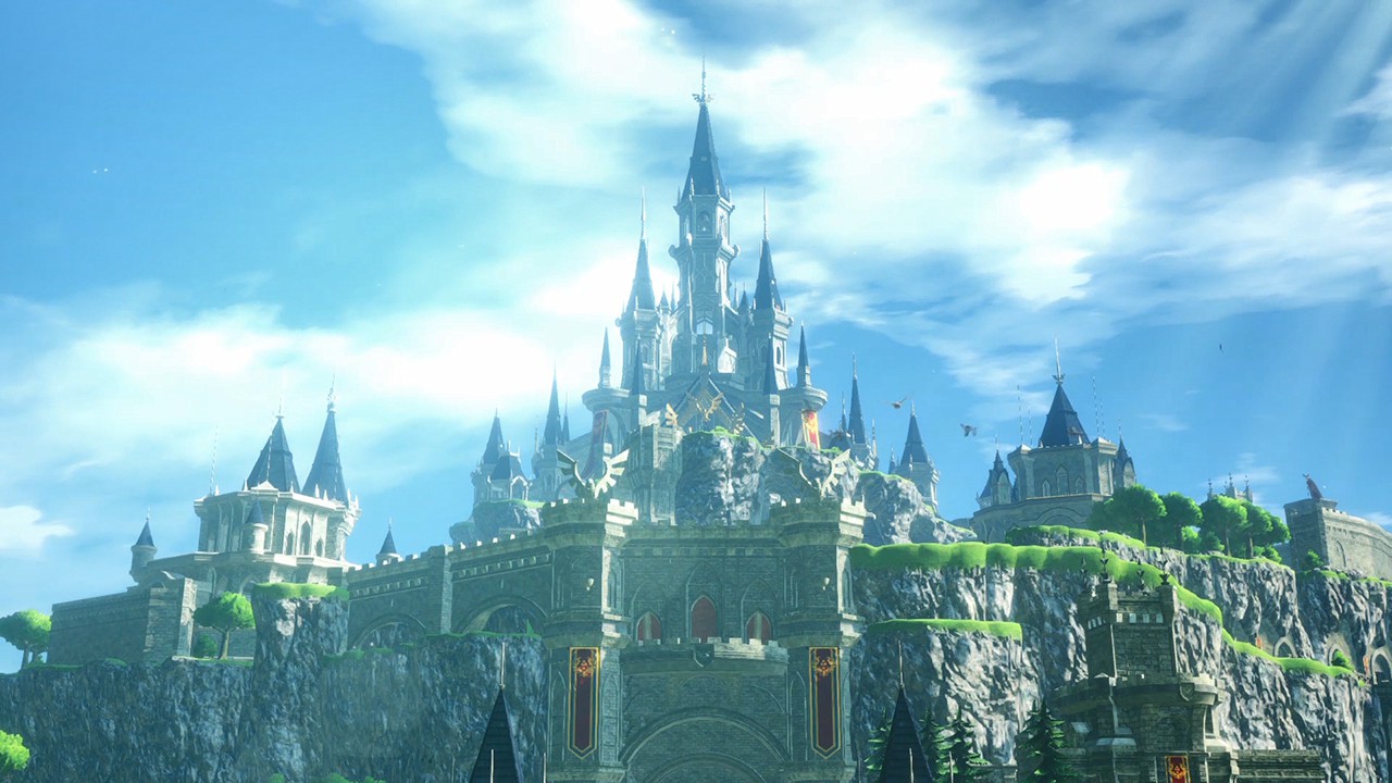 A large castle on a hill against a bright blue sky with clouds.