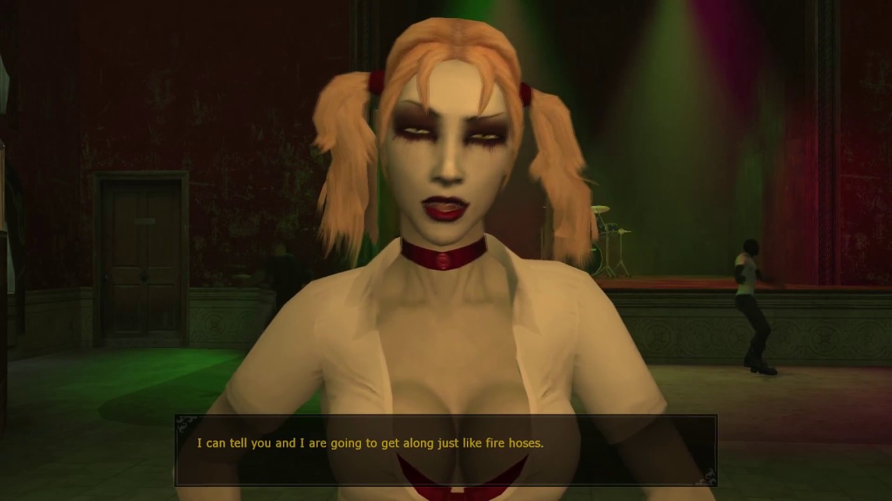 A woman with dark make up looks at the audience.