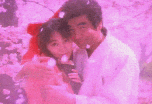 Segata Sanshiro holds Sakura close as the camera zooms and she nods. With cherry blossoms.