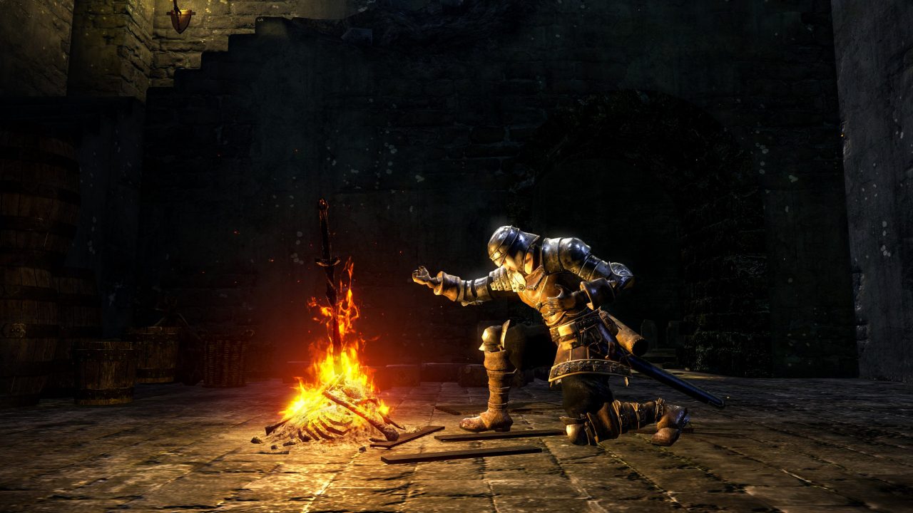 Dark Souls Trilogy Screenshot of a player character kneeling at a bonfire.