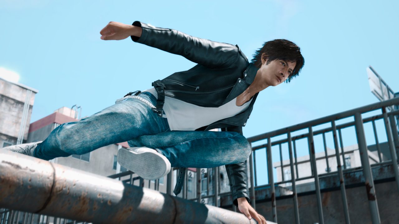 Yagami stylishly leaping over a large pipe with the skyline behind him.