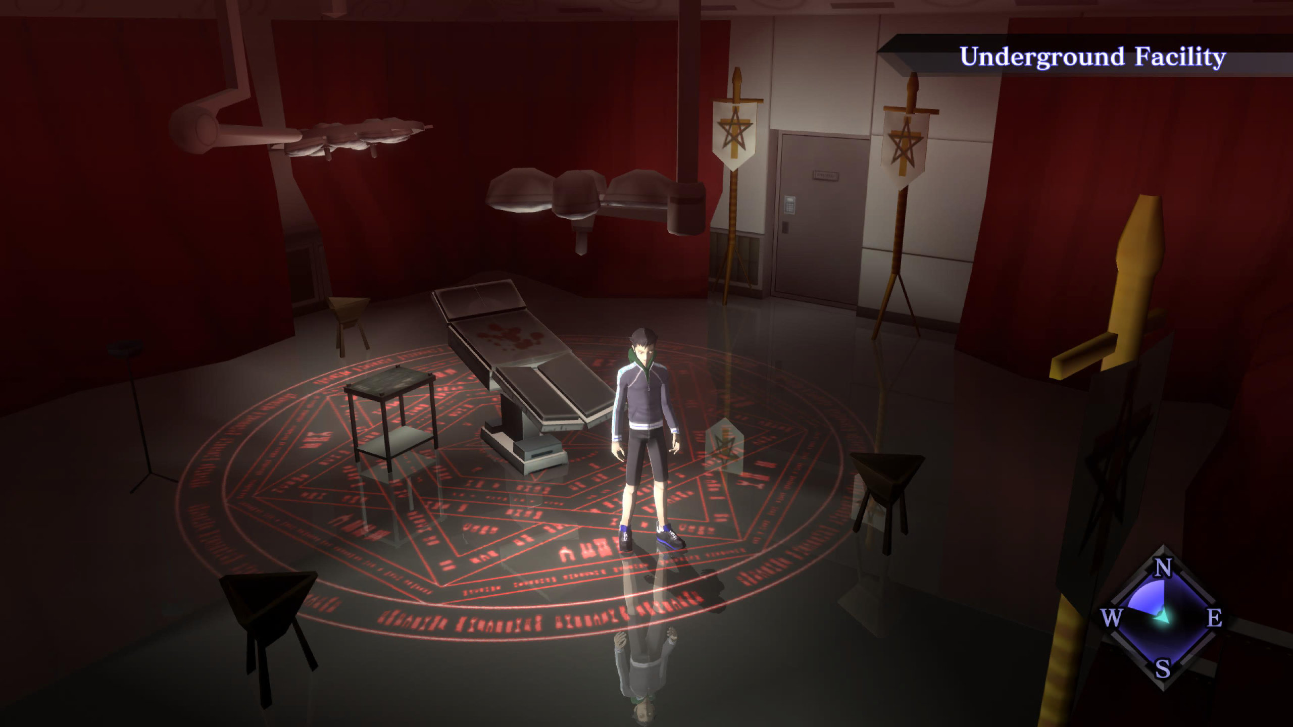 Shin Megami Tensei III: Nocturne HD Remaster screenshot of a boy wearing a hoodie stands in the center of a dimly lit room. Behind him a medical bed washed in blood sits atop an arcane symbol.