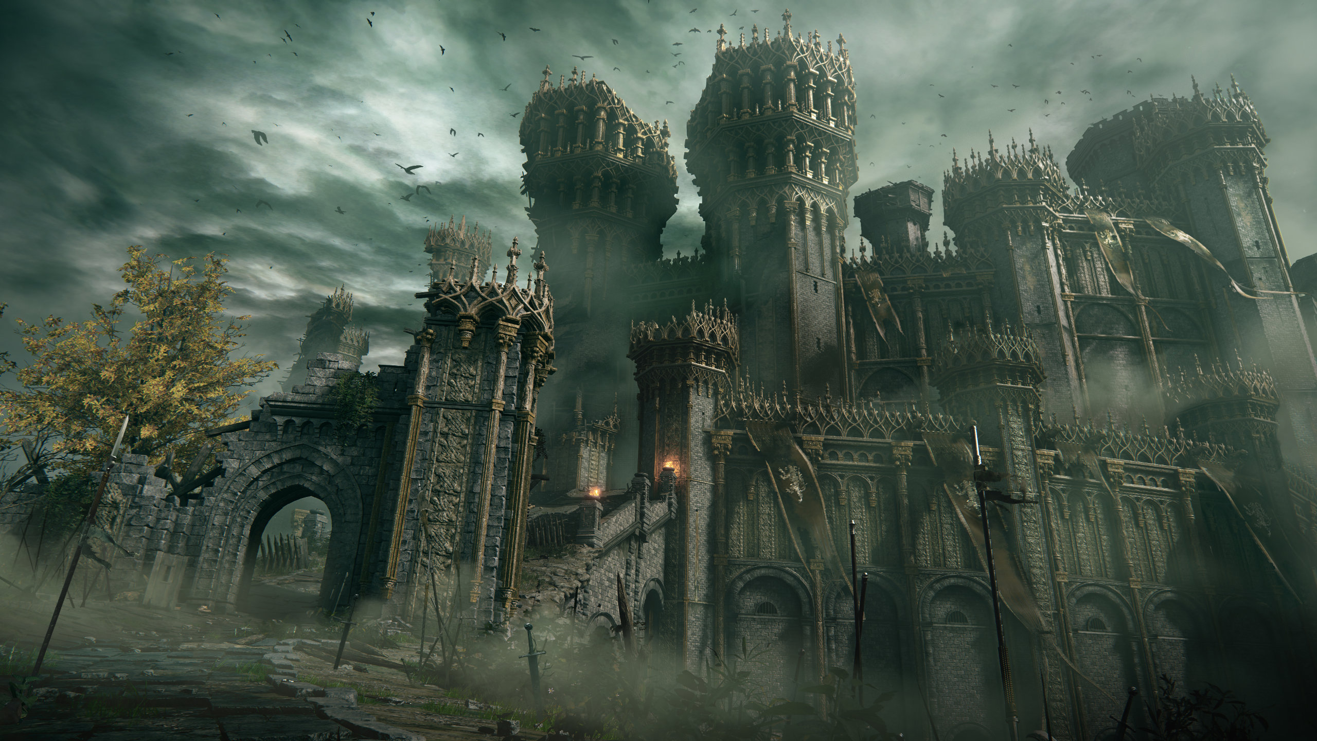 A screenshot of Elden Ring shows an imposing castle with barbed walls that stretch and tower over the protagonist.
