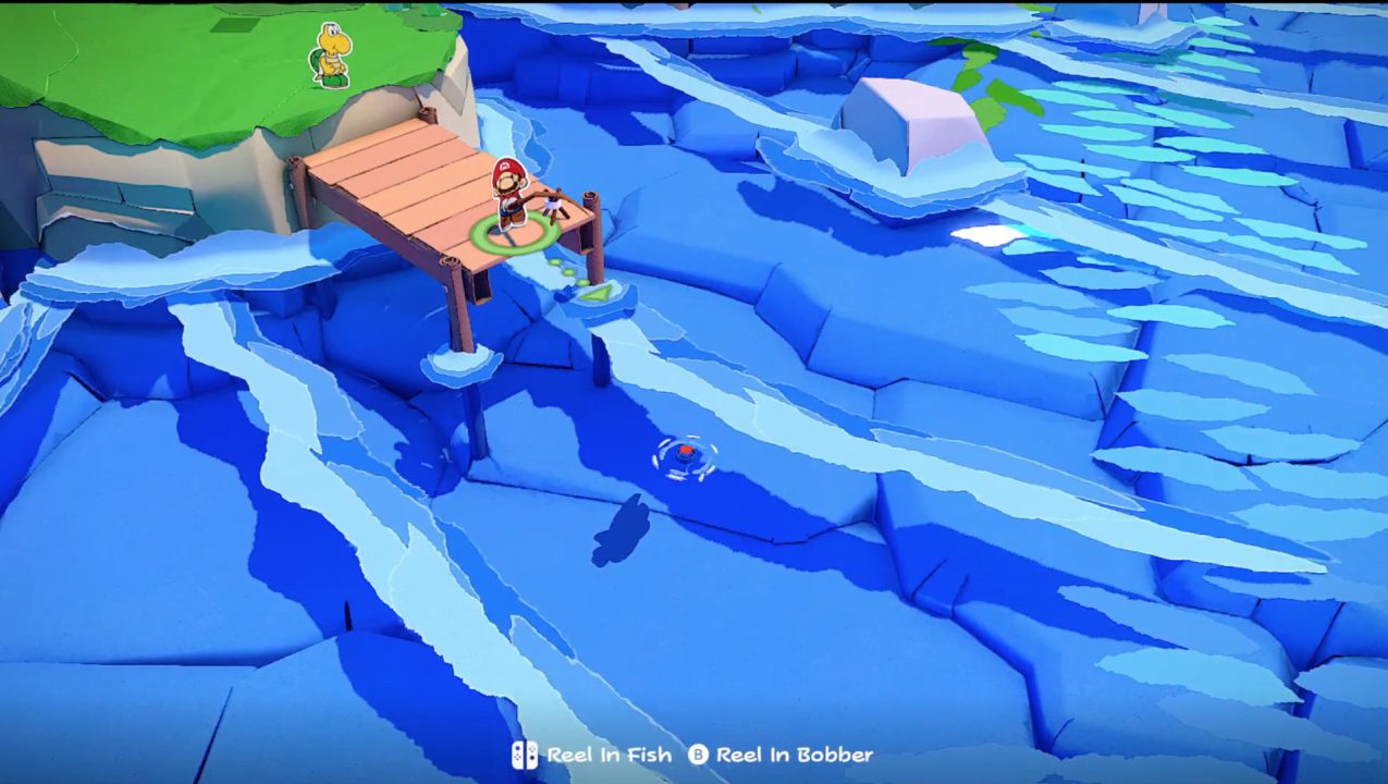 Paper Mario: The Origami King Screenshot of Mario casting a fishing line from a pier into crystal clear blue water