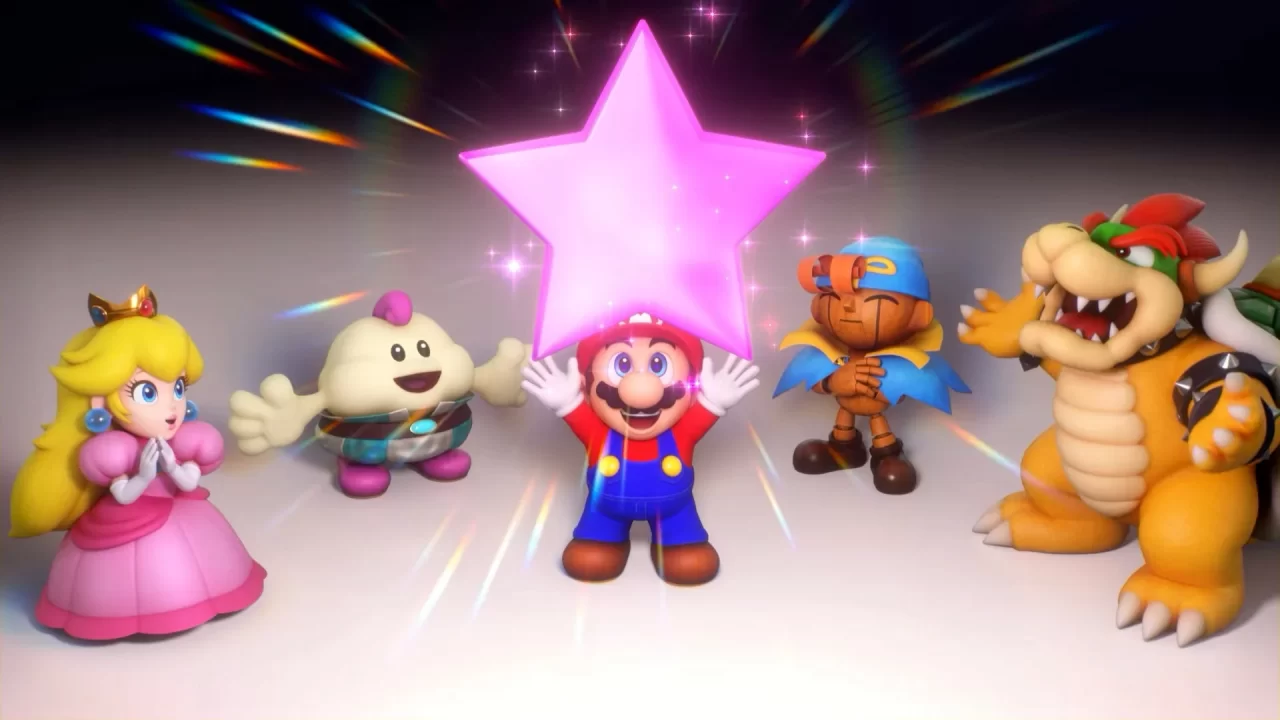 Screenshot of Super Mario RPG Remake showing Mario, center, holding up a purple pink star, while Peach and Mallow stand to the left and Geno and Bowser stand to the right, all smiling.