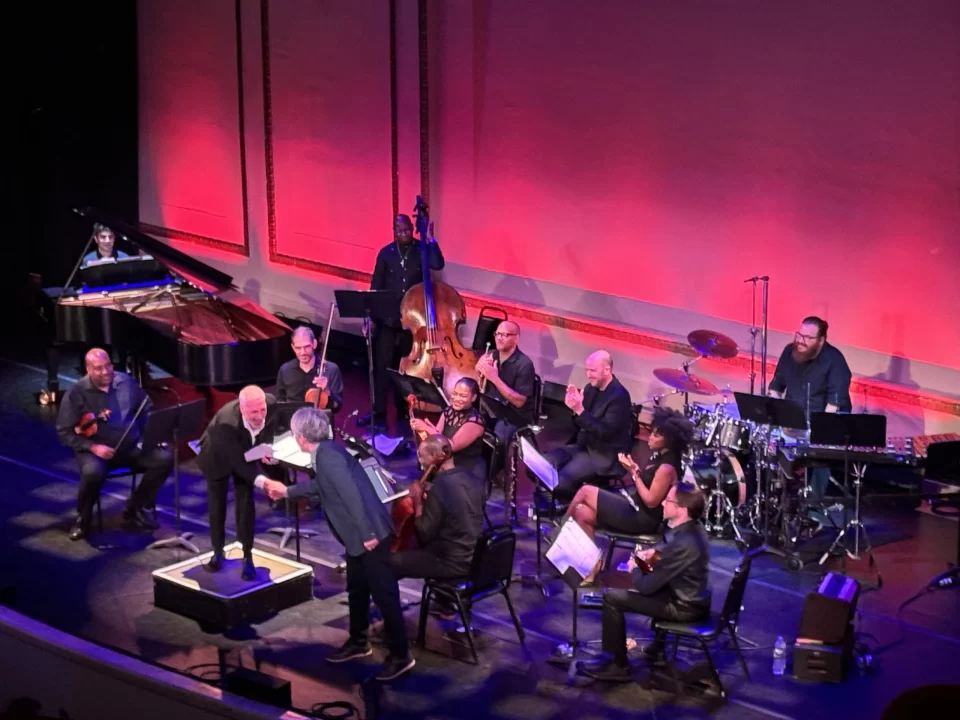 Masashi Hamauzu and Eric Roth shake hands at A New World Final Fantasy concert at The Town Hall in New York City.