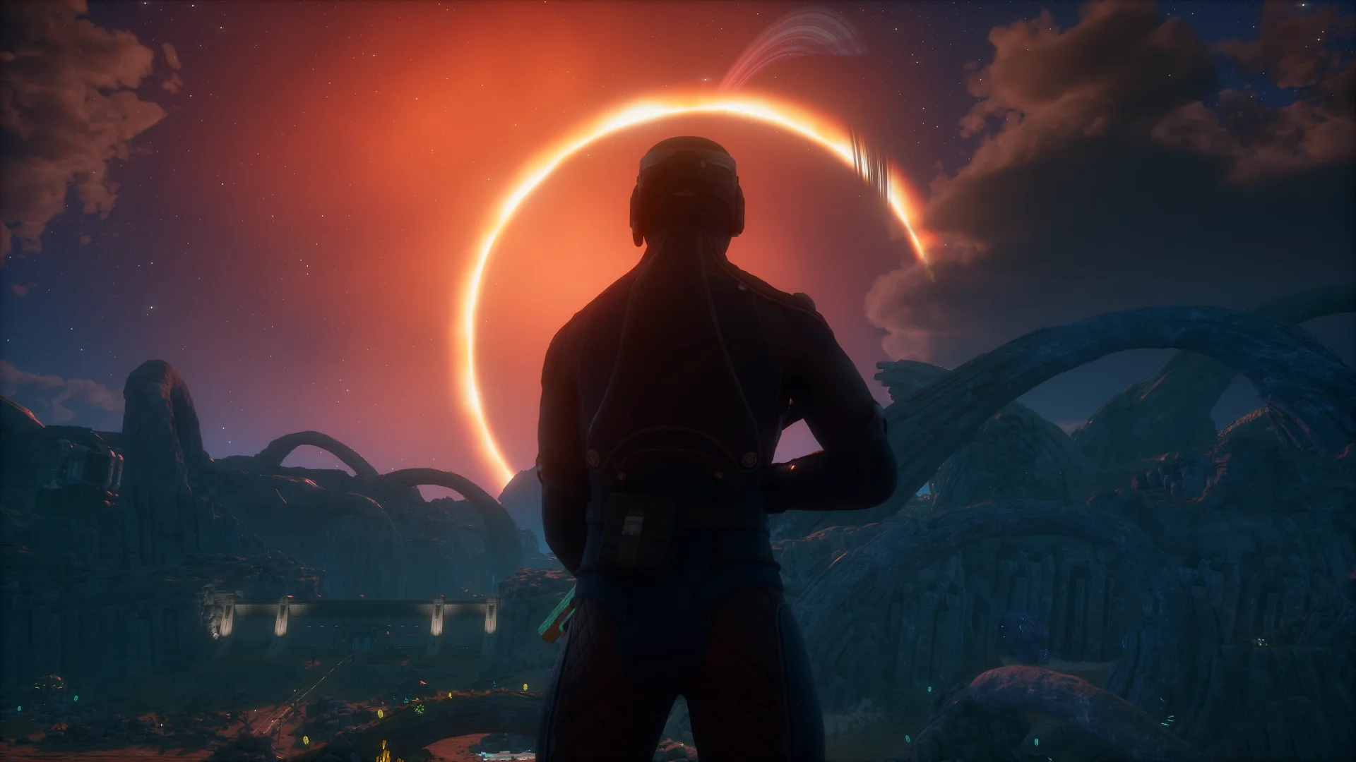 The Outer Worlds 2 screenshot of a figure with a gun silhouetted against an eclipse on a rocky alien world.
