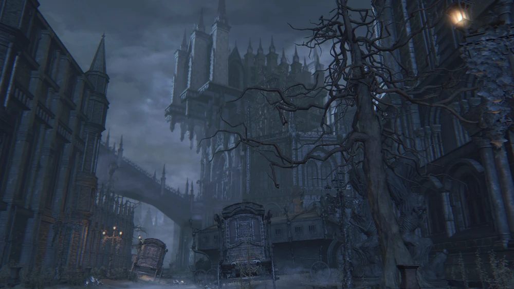 A screenshot from Bloodborne of the Hypogean Gaol, a Victorian-style prison with carriages outside and on the street and spires towering up into the grey skies.