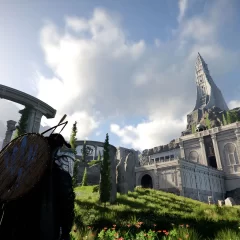 Approaching a stone tower on a mountain surrounded by other stone buildings.