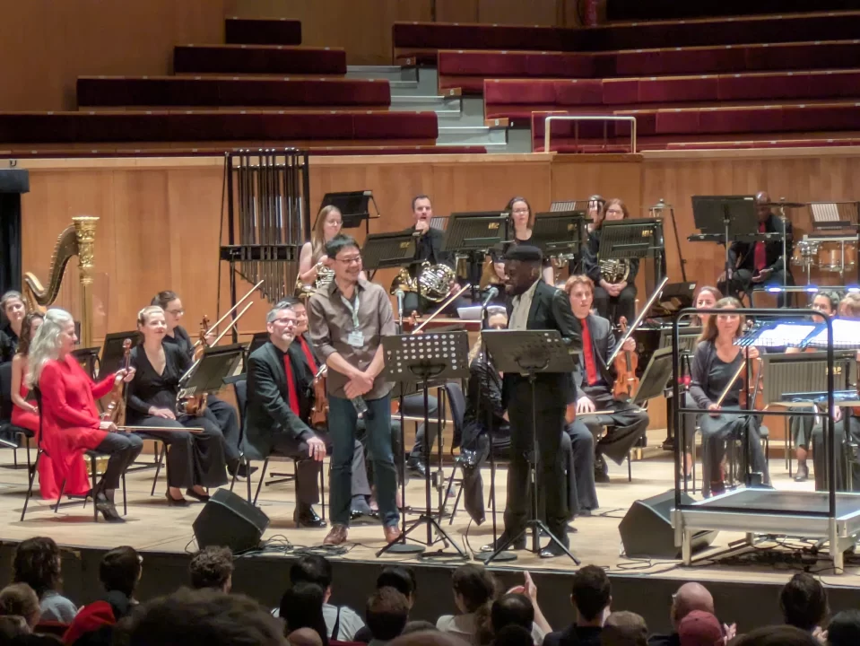 The conductor turning around during the Colors of Harmony concert.